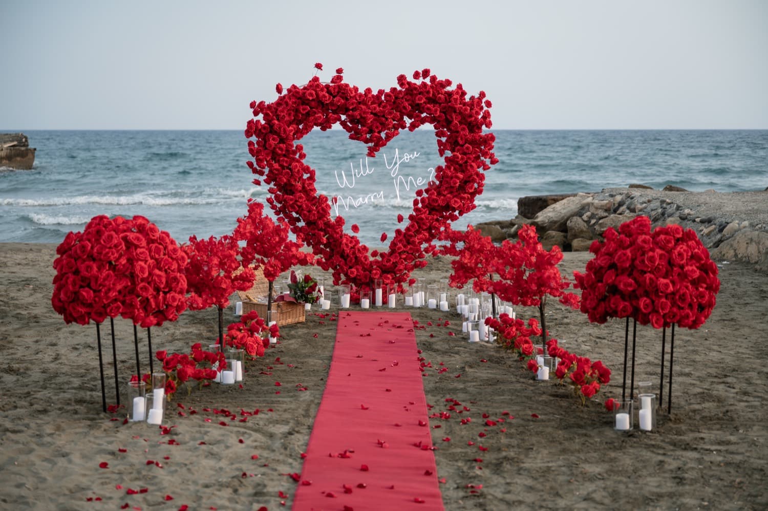 Red rose heart arch proposal on a Cyprus beach